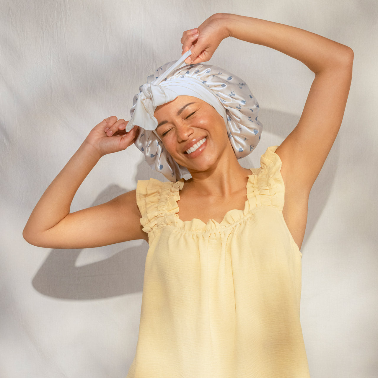509518-CoastalCottage-OversizedSatinBonnet-PearlizedCream_CoastalBlue-Model-2-1280x1280px